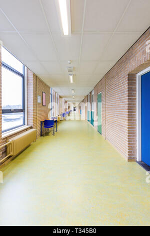 Long straight and empty corridor in secondary school building Stock Photo