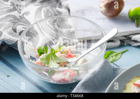 Bio organic avocado filled with homemade mayo, crab meat and herbs Stock Photo