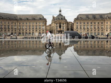 Bordeaux, France - September 9, 2018: The man performs acrobatics on a bicycle on Place de la Bourse, Bordeaux, France Stock Photo
