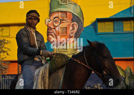 Worker on horseback + mural painting representing Subhas Chandra Bose, one of the most famous Indian nationalist of the XX° century ( India) Stock Photo