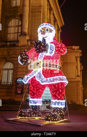 Zagreb, Croatia - 31th December, 2018 : A large illuminated Santa Claus in front of the Croatian National Theater building at Advent time. Stock Photo