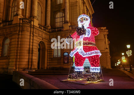 Zagreb, Croatia - 31th December, 2018 : A large illuminated Santa Claus in front of the Croatian National Theater building at Advent time. Stock Photo