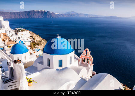 Santorini, Greece. Panoramic view with Greek orthodox church with blue domes and sea in Oia. Stock Photo