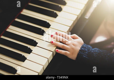 Close up of hand of girl toddler playing the piano. Stock Photo