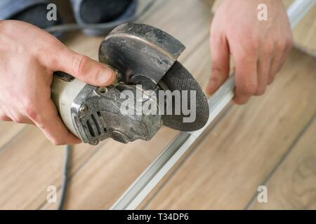 Tools for cutting tile, male using cutter. Stock Photo