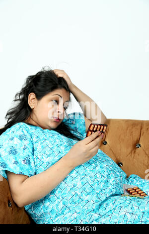 Pregnant woman is irritating in the medicine. Isolated on the white background. Stock Photo