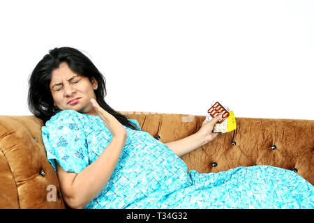 Picture of pregnant lady is irritating in the medicine. Isolated on the white background. Stock Photo