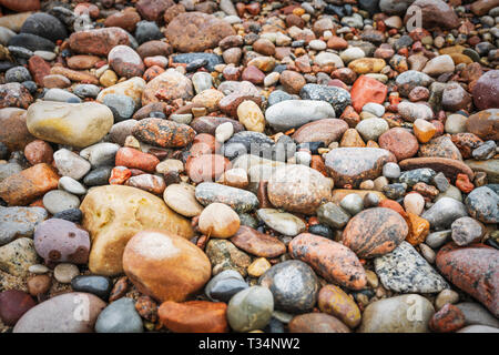 Many colorful stones on the beach of the Baltic Sea in Kolobrzeg, West Pomerania, Poland, Europe Stock Photo