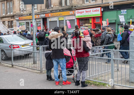 Glasgow, Scotland, UK. 6th April, 2019: Spectators watching the annual International Roma Day community procession through the streets of Govanhill to celebrate Romani culture and raise awareness of the issues facing Romani people. Credit: Skully/Alamy Live News Stock Photo