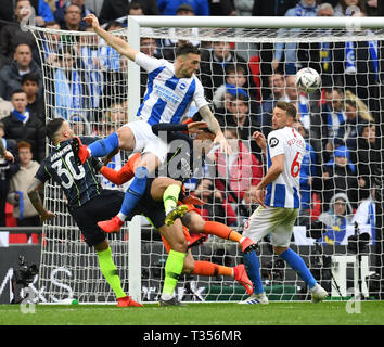 London, UK. 06th Apr, 2019. Brighton's Shane Duffy (top) leaps above Manchester City's Nicolas Otamedni (L) and Danilo (2nd R) to head the ball watched by Dale Stephens (6) during the FA Cup Semi-Final match between Manchester City and Brighton and Hove Albion at Wembley Stadium in London, Britain on April 6, 2019. Manchester City won 1-0.  FOR EDITORIAL USE ONLY. NOT FOR SALE FOR MARKETING OR ADVERTISING CAMPAIGNS. NO USE WITH UNAUTHORIZED AUDIO, VIDEO, DATA, FIXTURE LISTS, CLUB/LEAGUE LOGOS OR 'LIVE' SERVICES. ONLINE IN-MATCH USE LIMITED TO 45 IMAGES, NO VIDEO EMULATION. NO Credit: Xinhua/Al Stock Photo