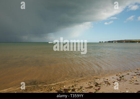 A storm front moving across Studland Bay in Dorset, UK. Old Harry rocks are in the background Stock Photo