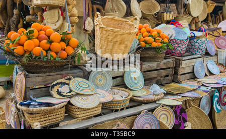 Craft wicker hats, bags, oranges and other souvenirs in the market of Morocco Stock Photo