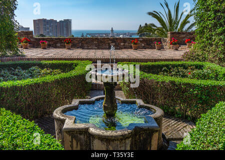 Fountain in garden and view in the alcazaba castle in Malaga Spain Stock Photo