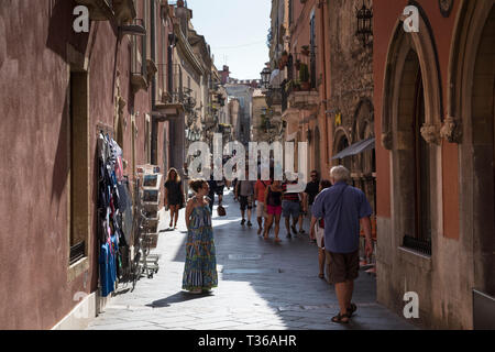 Tourists in street scene in the city of Taormina, East Sicily, Italy Stock Photo