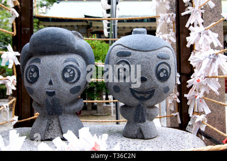Osaka, Kansai, Japan - 22nd September 2018 : Close up picture of the two small Ohatsu and Tokube stone statue at the Tsuyunoten Shrine in Umeda in Osa Stock Photo