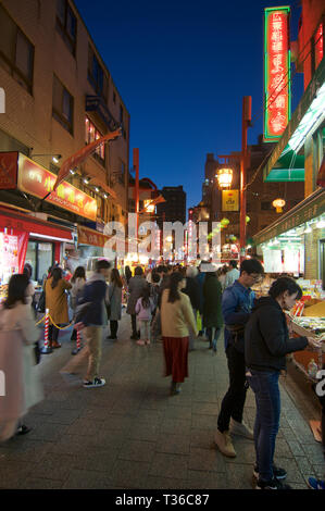 Kobe, Hyogo, Japan - 17th November 2018 : View of the busy street of Kobe's Chinatown at night in the Nankinmachi area in Kobe, Japan Stock Photo