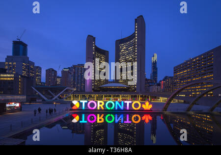 A night view of the 3D TORONTO sign, Toronto City Hall (New City Hall), and Nathan Phillips Square in downtown Toronto, Ontario, Canada. Stock Photo