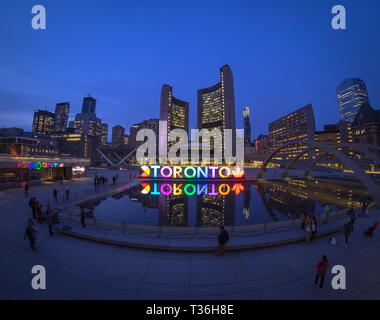 A night view of the 3D TORONTO sign, Toronto City Hall (New City Hall), and Nathan Phillips Square in downtown Toronto, Ontario, Canada. Stock Photo