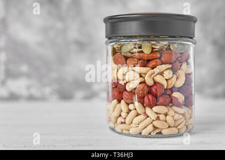 Different types of nuts and seeds in glass jar close up Stock Photo