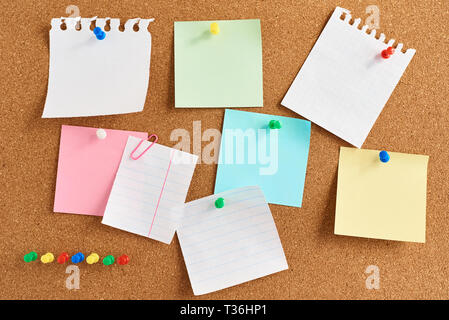 Cork board with pinned colored blank notes Stock Photo