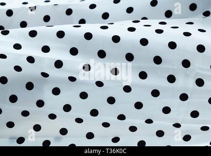 Fabric Texture, Close Up of Black and White Polka Dots Textile Pattern Background. Stock Photo