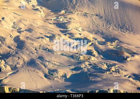 Avalanche debris on a glacier near Port charcot, Wilhelm Archipelago, Antarctica at sunset. Stock Photo