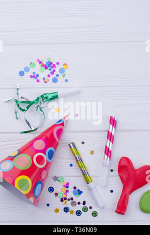 Birthday caps, blowers and confetti on background Stock Photo - Alamy