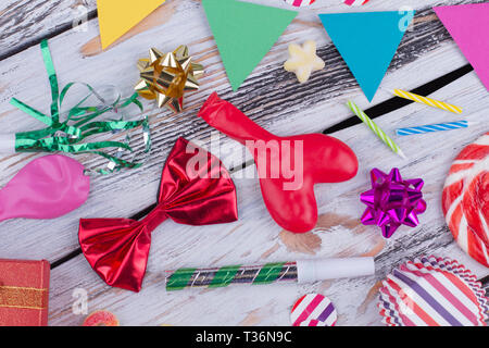 Carnival or Birthday party items. Birthday party accessories on vintage wooden boards. Holiday party decorations. Stock Photo