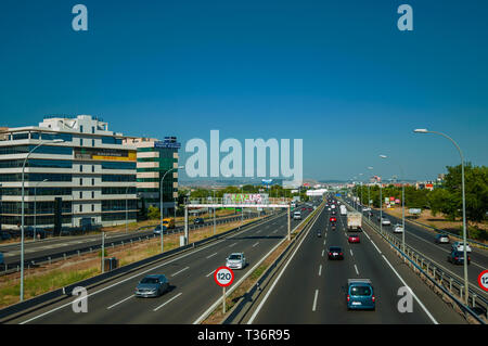 Highway with heavy traffic and SPEED LIMIT signposts at business district in Madrid. Capital of Spain with vibrant and intense cultural life. Stock Photo