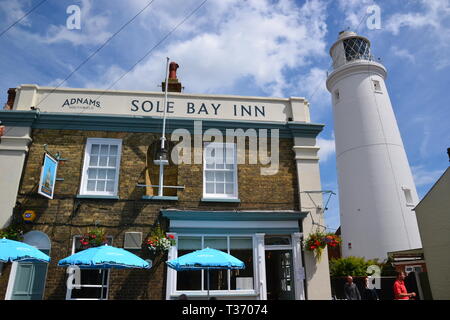 Southwold Lighthouse beside the Sole Bay Inn, in Southwold, Suffolk, UK Stock Photo