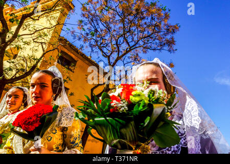 Valencia Fallas festival, young Spanish women marching trough city with flowers in traditional costumes, Spain Las Fallas Valencia Spain  Europe Stock Photo