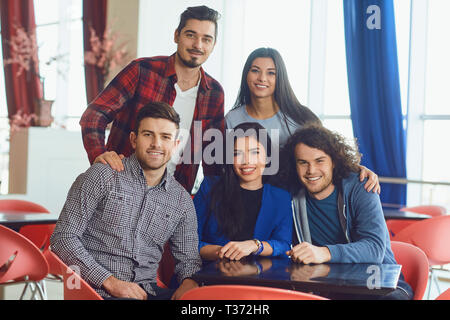 Portrait of happy friends in cafe. Stock Photo