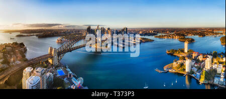 Elevated aerial view over Lavender bay on Sydney harbour from Lower North Shore towards city CBD around the Sydney Harbour bridge , the rocks and Bara Stock Photo