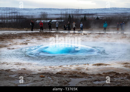 A favorite stop along the Golden Circle is the highly active Geysir Hot Spring Area with boiling mud pits, exploding geysers and the lively Strokkur w Stock Photo