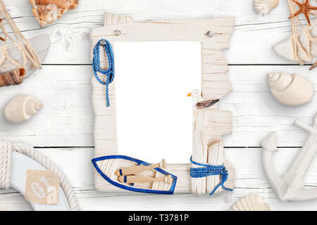 Summer travel photo family isolated frame for mockup surrounded with shells on white wooden table. Stock Photo