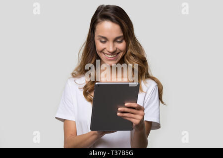 Woman using gadget looking at digital tablet screen studio shot Stock Photo