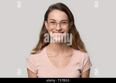 Smiling woman in glasses looking at camera studio shot Stock Photo
