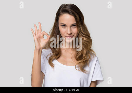 Attractive woman posing in studio showing ok sign Stock Photo