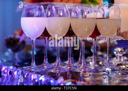 Glasses with wine. Many glass of wine on a table. Filled with half and stand on the holiday table. Furshet. selective focus Stock Photo