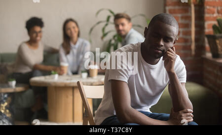 Upset lonely african american man suffering from bullying racial discrimination Stock Photo