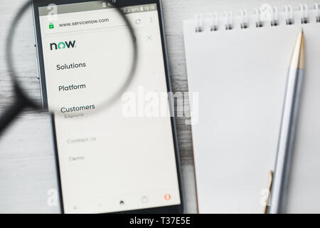 Los Angeles, California, USA - 3 April 2019: ServiceNow Enterprise software official website homepage under magnifying glass. Concept ServiceNow Stock Photo