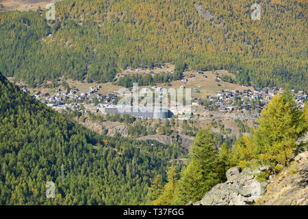 The Swiss mountain resort of Saas Fee, surrounded by pines, larches and high mountains Stock Photo