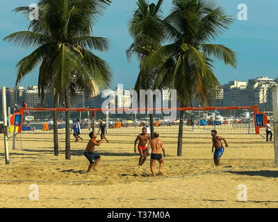 RIO DE JANEIRO, BRAZIL- 27, MAY, 2016: long shot of a men's footvolley game on copacabana beach in rio Stock Photo