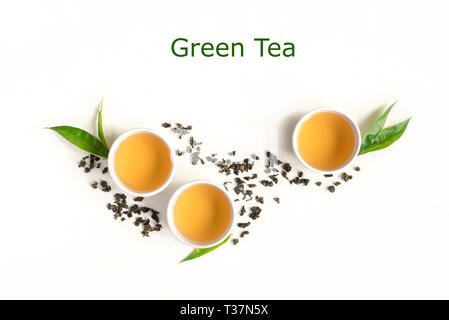 Green tea in ceramic cups, dry green oolong tea and tea leaves isolated on white, copy space. Stock Photo