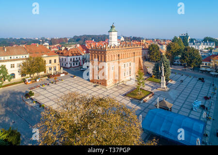 Sandomierz old city, Poland. Aerial view in sunrise light. Gothic city hall with clock tower and Renaissance attic and St Mary statue in the market Sq
