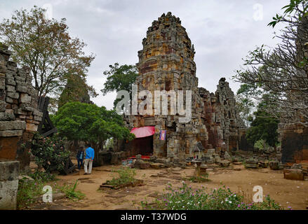 Phnom Banan, Cambodia.The beautiful crumbling towers of Prasat Banan at the top of Phnom Banan mountain with a shrine where people pray 15-12-2018 Stock Photo