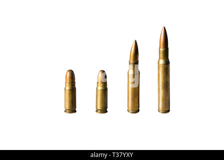 Four pieces of sharp ammunition with caliber 8mm and 12.7mm standing in a row, isolated on a white background with a clipping path and space for text. Stock Photo