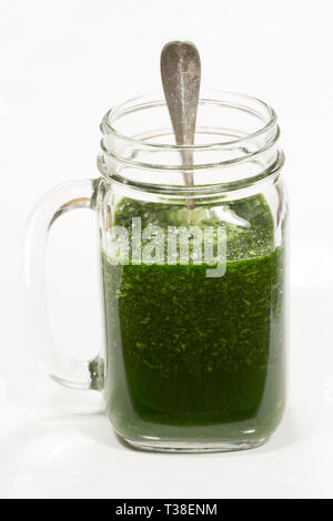 Spinach smoothy in a glass on white background Stock Photo