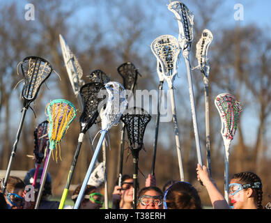 High school lacrosse team raising their sticks prior to a match Stock Photo