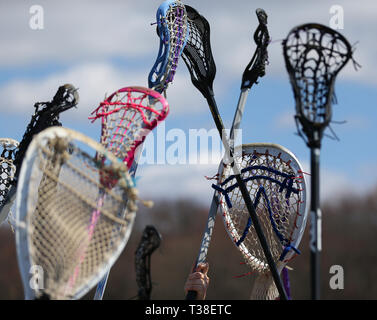 High school lacrosse team raising their sticks prior to a match Stock Photo